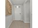 This entryway features neutral paint, tile floors, and a stylish wall decoration at 16031 Alcira Cir, Punta Gorda, FL 33955