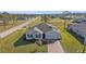 A well-maintained home exhibits appealing curb appeal with a brick driveway and lush lawn in a neighborhood setting at 16031 Alcira Cir, Punta Gorda, FL 33955