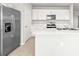 Modern kitchen features white cabinets, stainless appliances, and an island at 16031 Alcira Cir, Punta Gorda, FL 33955