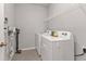 Functional laundry room features a washer, dryer, shelving, and cleaning equipment at 16031 Alcira Cir, Punta Gorda, FL 33955