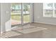 Sun-filled living room with sliding glass door and tile flooring at 16031 Alcira Cir, Punta Gorda, FL 33955