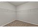 Empty walk-in closet featuring gray walls, carpet floors, and metal shelving at 16031 Alcira Cir, Punta Gorda, FL 33955