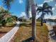 Pathway to canal, tropical landscaping, and fire pit at 193 N Waterway Nw Dr, Port Charlotte, FL 33952