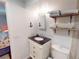 Charming bathroom with updated vanity and rustic shelving at 193 N Waterway Nw Dr, Port Charlotte, FL 33952