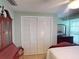Simple bedroom with a wooden bed and built-in closet at 193 N Waterway Nw Dr, Port Charlotte, FL 33952