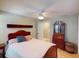 Relaxing bedroom with a ceiling fan and wooden dresser at 193 N Waterway Nw Dr, Port Charlotte, FL 33952