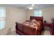 Comfortable bedroom with a ceiling fan and a patchwork quilt at 193 N Waterway Nw Dr, Port Charlotte, FL 33952
