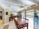 Spacious dining area with long table, pool access, and ceiling fan at 193 N Waterway Nw Dr, Port Charlotte, FL 33952