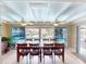 Bright dining room with large table, pool view, and wood ceiling at 193 N Waterway Nw Dr, Port Charlotte, FL 33952