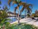 Private dock with covered boat lift and palm trees at 193 N Waterway Nw Dr, Port Charlotte, FL 33952