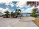Tropical landscaping surrounds a light blue house at 193 N Waterway Nw Dr, Port Charlotte, FL 33952
