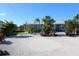 Home exterior with palm trees and gravel driveway at 193 N Waterway Nw Dr, Port Charlotte, FL 33952