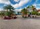 Landscaped front yard with tropical plants and stone pathway at 193 N Waterway Nw Dr, Port Charlotte, FL 33952