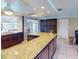 Open kitchen with granite counters and dark wood cabinets at 193 N Waterway Nw Dr, Port Charlotte, FL 33952