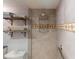 Walk-in shower with tiled walls and built-in shelving at 193 N Waterway Nw Dr, Port Charlotte, FL 33952