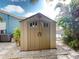 Tan plastic storage shed in backyard setting at 193 N Waterway Nw Dr, Port Charlotte, FL 33952