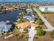 Aerial view of waterfront home with canal access and lush landscaping at 2100 Cassino Ct, Punta Gorda, FL 33950