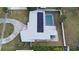 Aerial view of a home with solar panels on the roof and a screened-in pool at 22143 Lasalle Rd, Port Charlotte, FL 33952