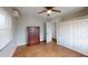 Cozy bedroom showcasing updated floors, fresh paint, ceiling fan, and ample closet space for storage at 22143 Lasalle Rd, Port Charlotte, FL 33952