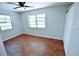 Bedroom with light walls, wood-look tile flooring, and two windows at 22143 Lasalle Rd, Port Charlotte, FL 33952