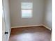 This bedroom features beautiful wood-look floors and a bright window, creating a cozy and inviting space at 22143 Lasalle Rd, Port Charlotte, FL 33952