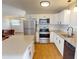 Bright kitchen featuring stainless appliances, granite counters, white cabinets, and a convenient kitchen island at 22143 Lasalle Rd, Port Charlotte, FL 33952