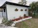 Charming exterior with a rock garden and flower boxes adding curb appeal to the property at 22143 Lasalle Rd, Port Charlotte, FL 33952
