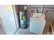 This laundry area features a modern washing machine and a functional water heater for efficiency at 22143 Lasalle Rd, Port Charlotte, FL 33952