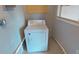 Laundry room featuring a white washing machine with overhead cabinets and a nearby electrical outlet at 22143 Lasalle Rd, Port Charlotte, FL 33952