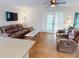 Spacious living room featuring comfortable seating, a sliding glass door, and stylish decor at 22143 Lasalle Rd, Port Charlotte, FL 33952