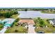 Beautiful aerial view of a lakefront home with lush landscaping and a brick driveway at 2259 Kenya Ln, Punta Gorda, FL 33983