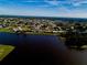 Beautiful aerial view of the community homes around a scenic lake under a clear blue sky at 2259 Kenya Ln, Punta Gorda, FL 33983