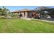 Spacious backyard features lush green grass, screened-in patio and garden area at 2259 Kenya Ln, Punta Gorda, FL 33983