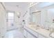 Bathroom featuring white cabinetry, tile floors, and a door to the exterior at 2259 Kenya Ln, Punta Gorda, FL 33983
