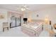 Bedroom features tile floors, ceiling fan, and access to outdoor pool area at 2259 Kenya Ln, Punta Gorda, FL 33983
