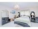 Cozy bedroom with chandelier, tile floors, and plenty of furniture at 2259 Kenya Ln, Punta Gorda, FL 33983