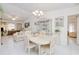 Bright dining area with a view into the living room, featuring a modern chandelier and neutral decor at 2259 Kenya Ln, Punta Gorda, FL 33983