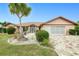 Charming single-story home featuring a mature palm tree and a well-maintained lawn at 2259 Kenya Ln, Punta Gorda, FL 33983