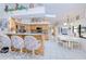 Open kitchen and breakfast area with bar seating and white tile flooring throughout at 2259 Kenya Ln, Punta Gorda, FL 33983