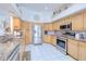 Bright kitchen with stainless steel appliances, granite countertops and light wood cabinets at 2259 Kenya Ln, Punta Gorda, FL 33983
