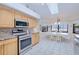 Bright kitchen features stainless steel appliances and a breakfast nook with water views at 2259 Kenya Ln, Punta Gorda, FL 33983