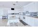 Bright kitchen with white cabinets, modern appliances, and a breakfast table for casual dining at 2259 Kenya Ln, Punta Gorda, FL 33983