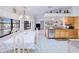 Open kitchen and dining area with stainless steel appliances, granite countertops, and tile flooring at 2259 Kenya Ln, Punta Gorda, FL 33983