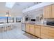 Charming kitchen and breakfast nook illuminated by natural light and featuring white tile floors at 2259 Kenya Ln, Punta Gorda, FL 33983