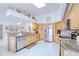 Well-lit kitchen with wood cabinets, granite countertops, tile flooring and stainless steel appliances at 2259 Kenya Ln, Punta Gorda, FL 33983