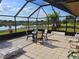 Screened lanai overlooking a lake, perfect for outdoor dining at 2259 Kenya Ln, Punta Gorda, FL 33983