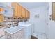 Functional laundry room with modern washer and dryer, ample storage, and a practical sink area at 2259 Kenya Ln, Punta Gorda, FL 33983