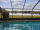 Inviting pool with lake view from screened enclosure at 2259 Kenya Ln, Punta Gorda, FL 33983