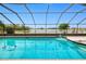 Relaxing screened-in pool area with clear blue water and scenic waterfront views at 2259 Kenya Ln, Punta Gorda, FL 33983