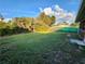 Large grassy backyard with lush landscaping at 23104 Rountree Ave, Port Charlotte, FL 33980